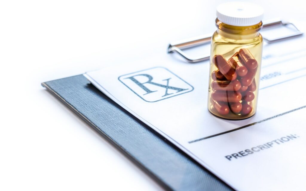 Pills at doctors office and rx prescription paper